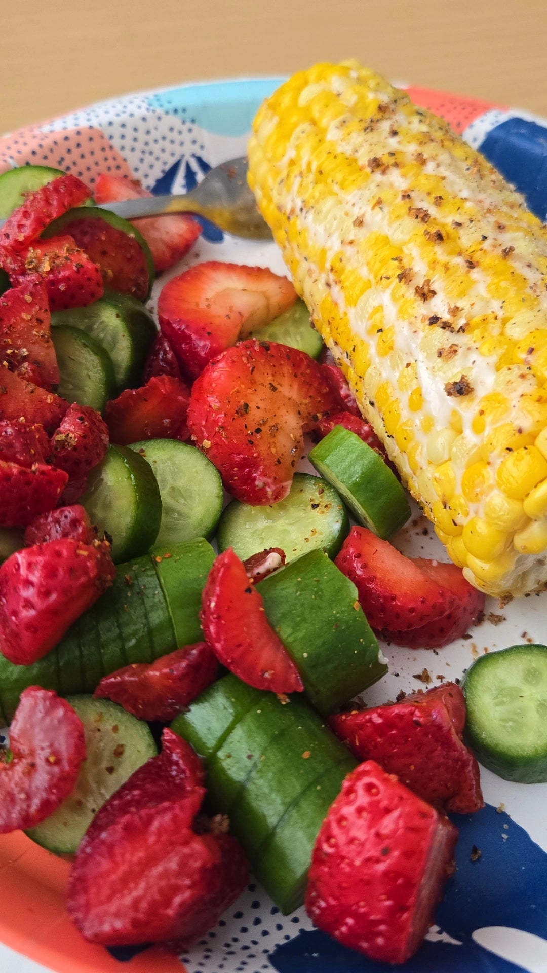 Strawberry and cucumber salad with seasoned corn on the cob